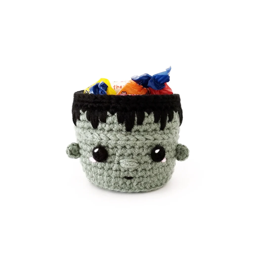 A small Frankenstein basket filled with wrapped candy.